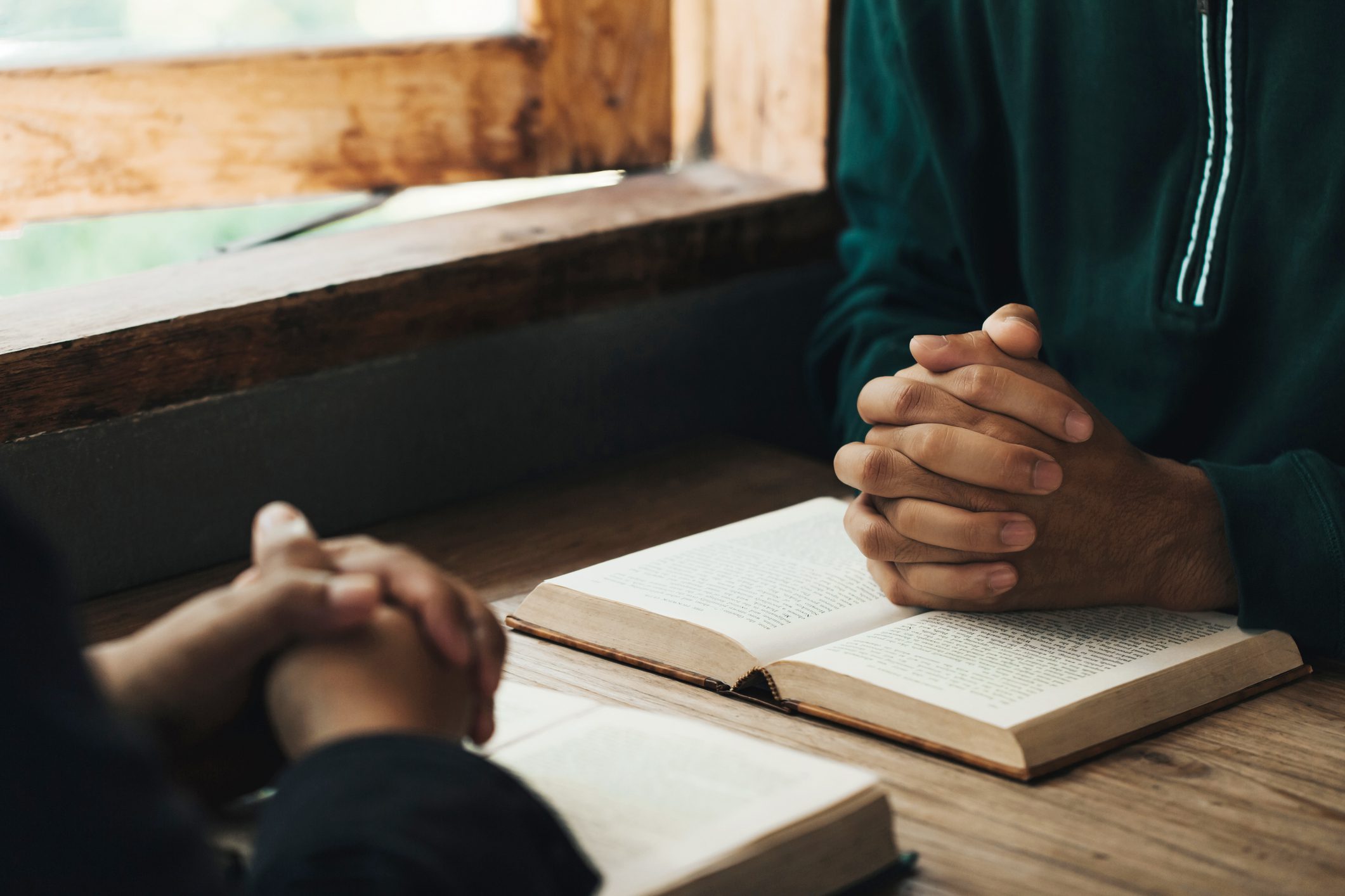 People praying with open books